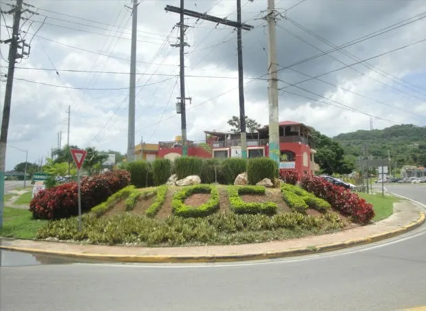 A welcome sign and green hills at Moca, Puerto Rico, the town where the 1975 animal deaths took place.