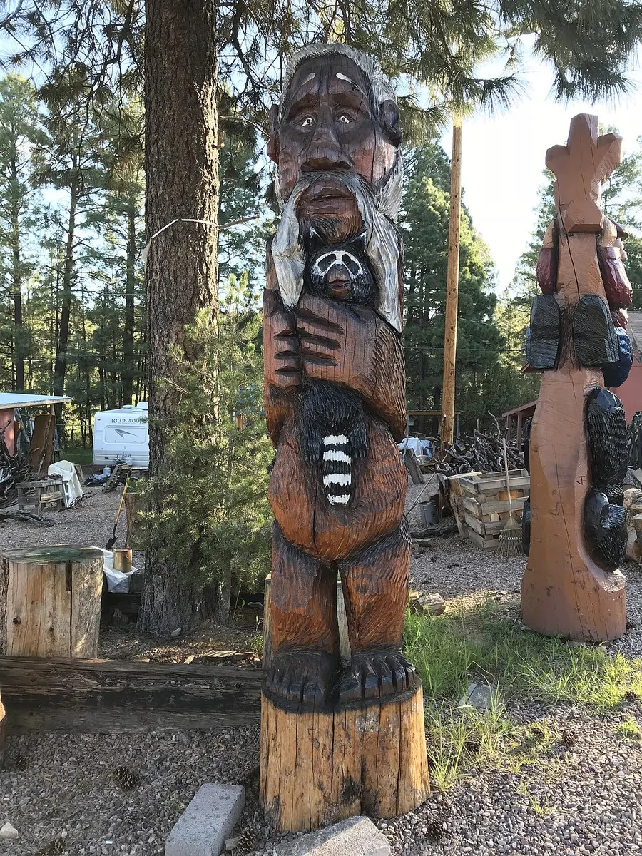 A chainsaw wood carving of the Mogollon Monster, a tall, hairy ape-like figure