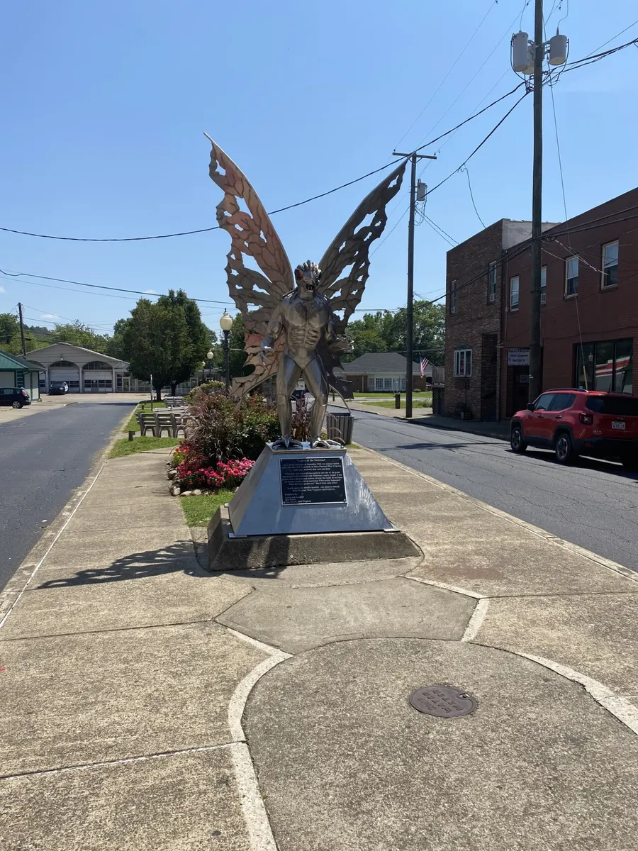 The stainless-steel Mothman statue with spread wings on a street in Point Pleasant, West Virginia