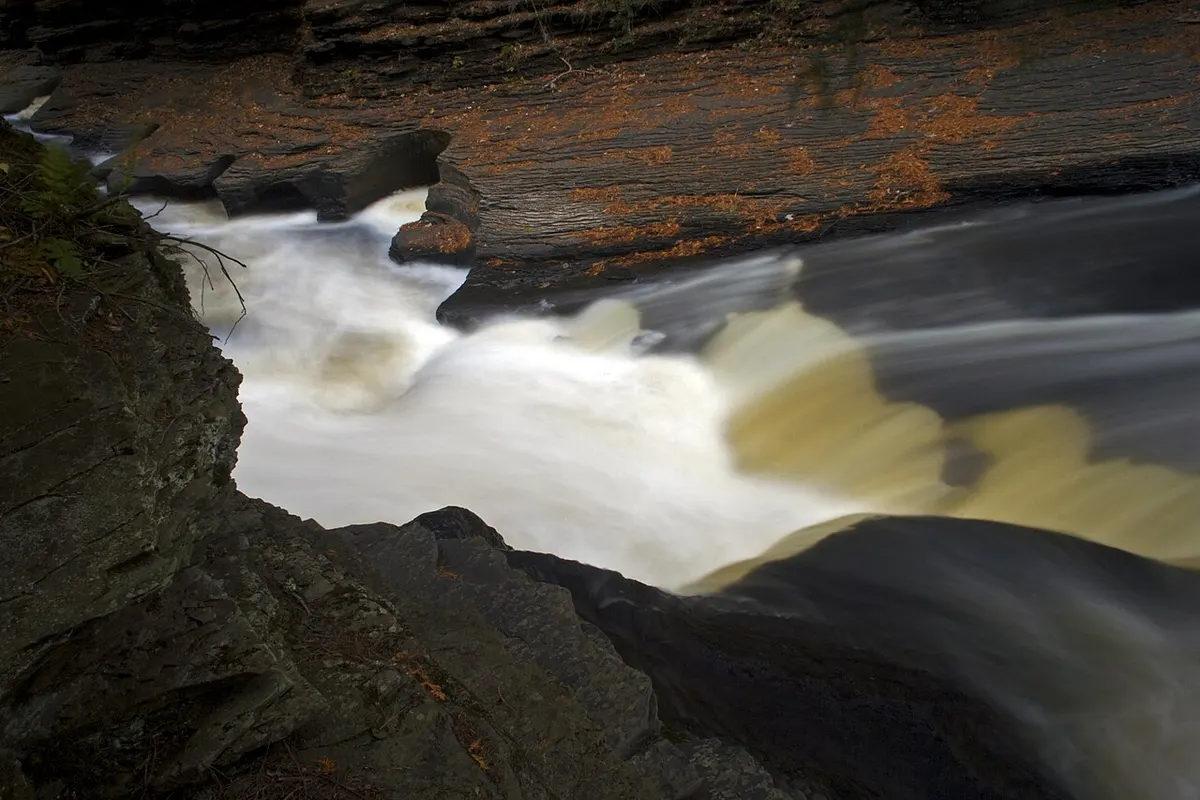 The Presque Isle River flowing over rock ledges in Michigan’s Upper Peninsula