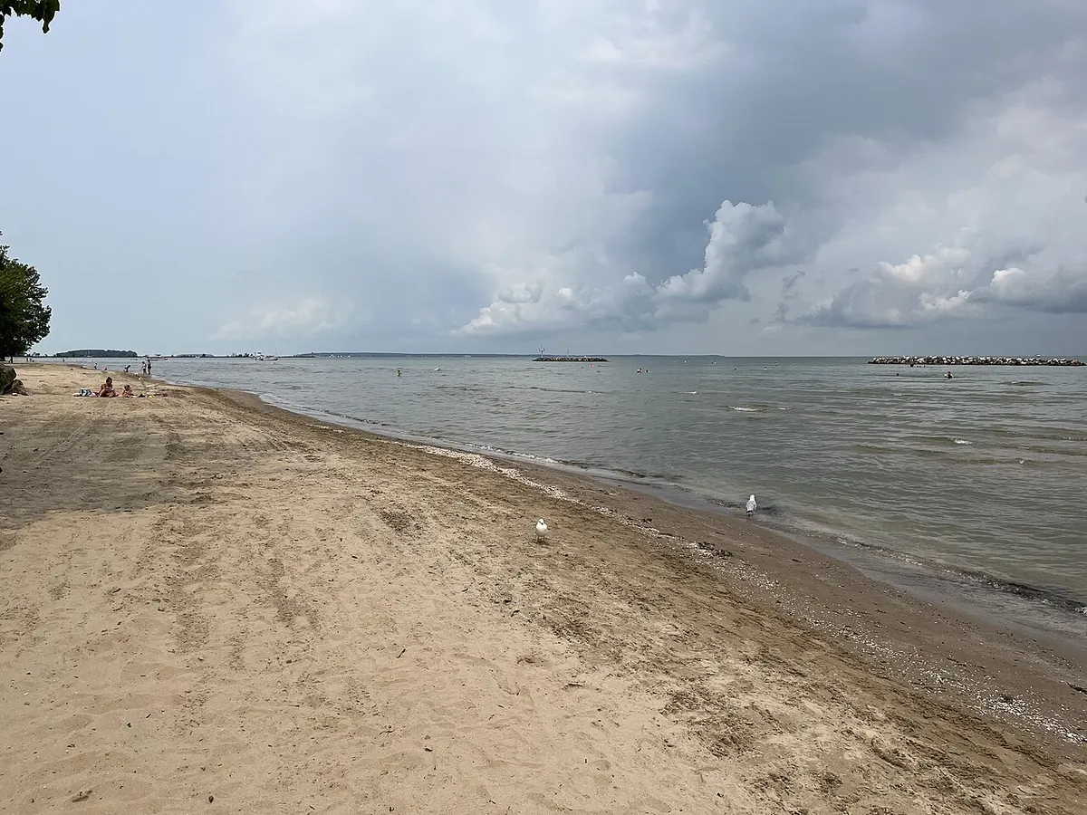 A sandy beach with gentle waves at East Harbor State Park on Lake Erie, Ottawa County, Ohio
