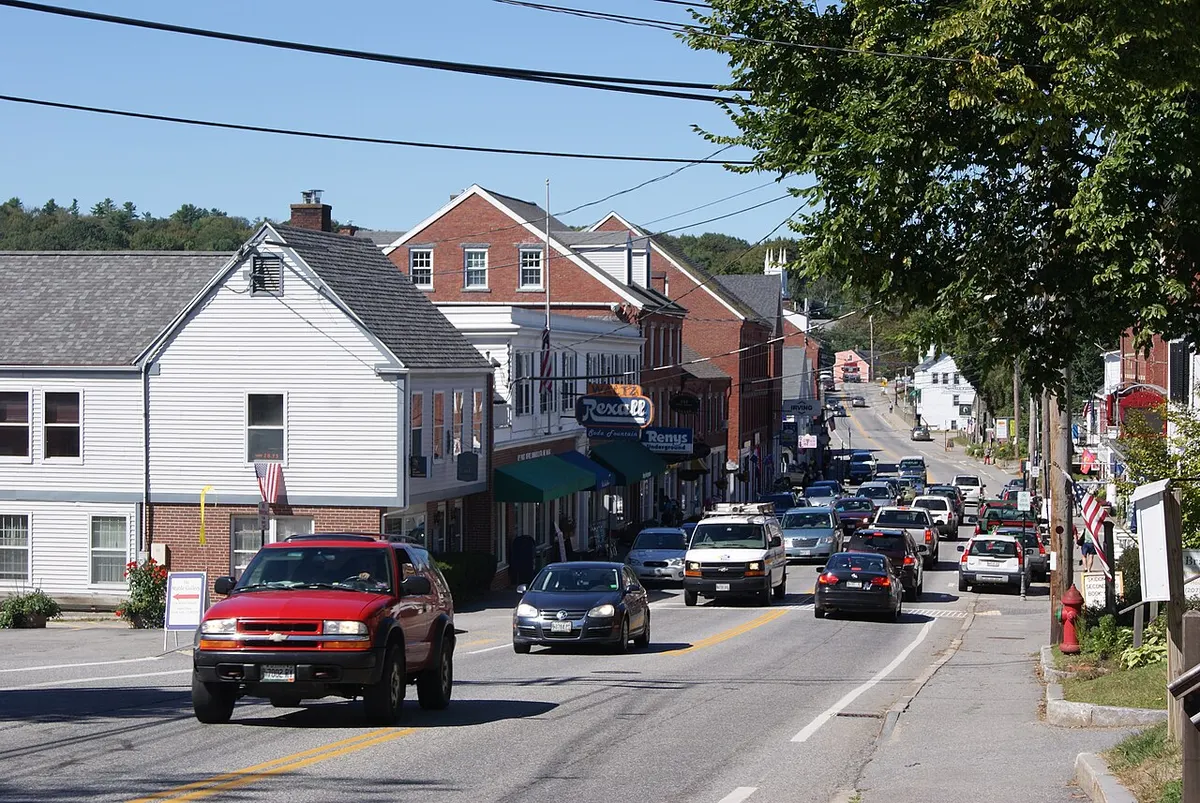 Brick and clapboard storefronts lining Main Street in Damariscotta, Maine, on a sunny day