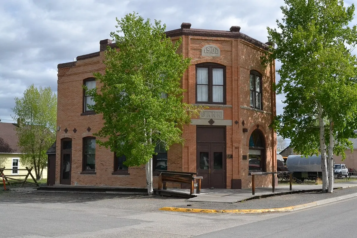 The two-story red-brick former First National Bank building on a quiet street corner in Meeteetse, Wyoming
